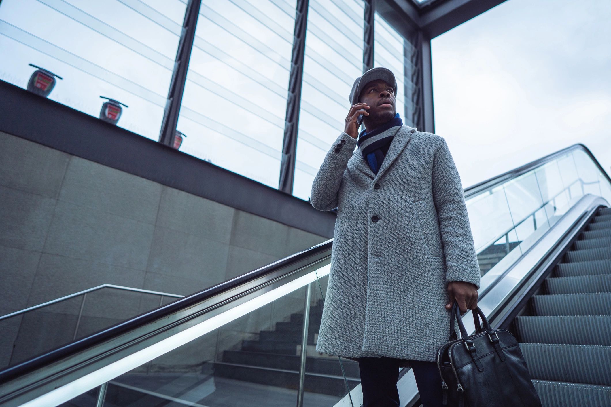 Business traveler using smartphone in airport terminal