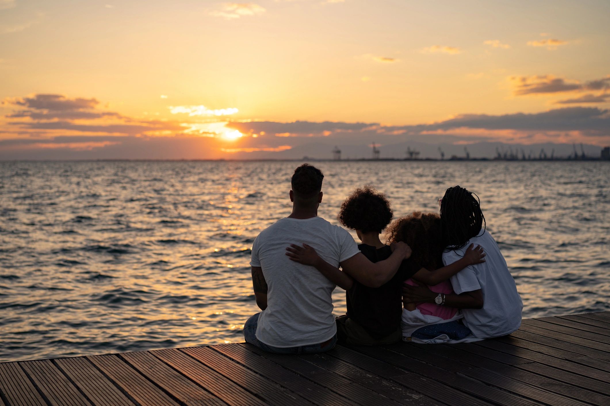 Family enjoying a sunset by the sea