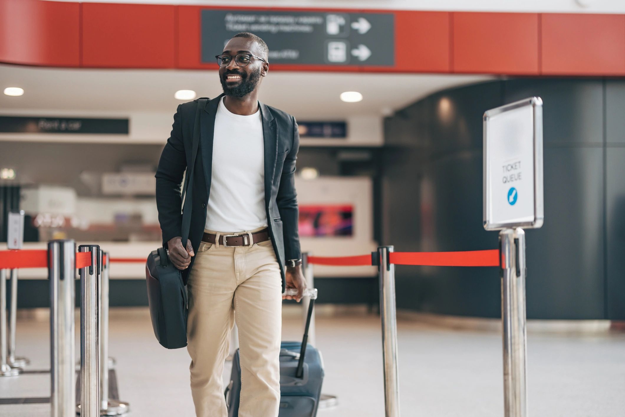 Traveler walking through airport with luggage