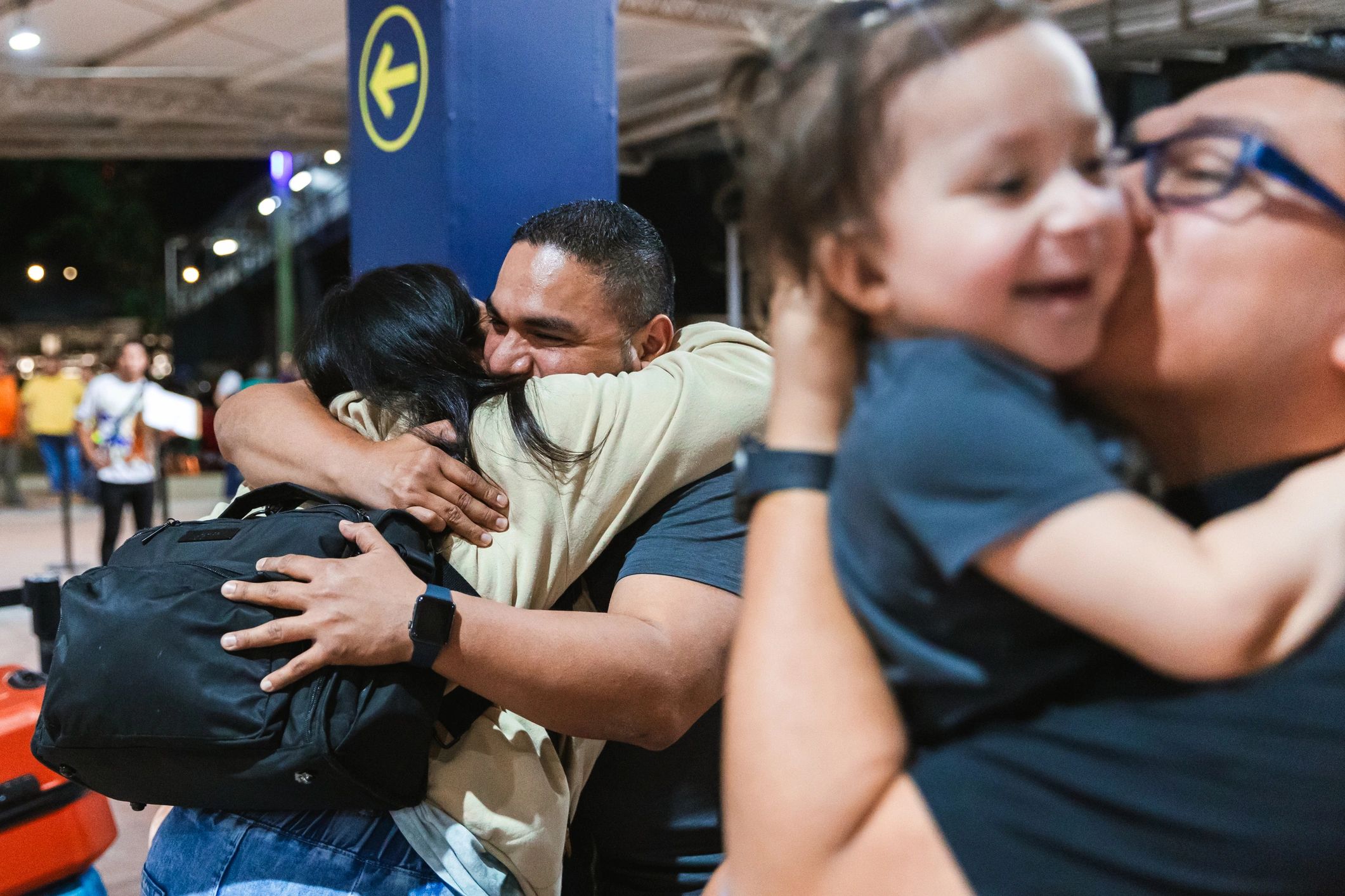 Travelers greeting family outside an airport