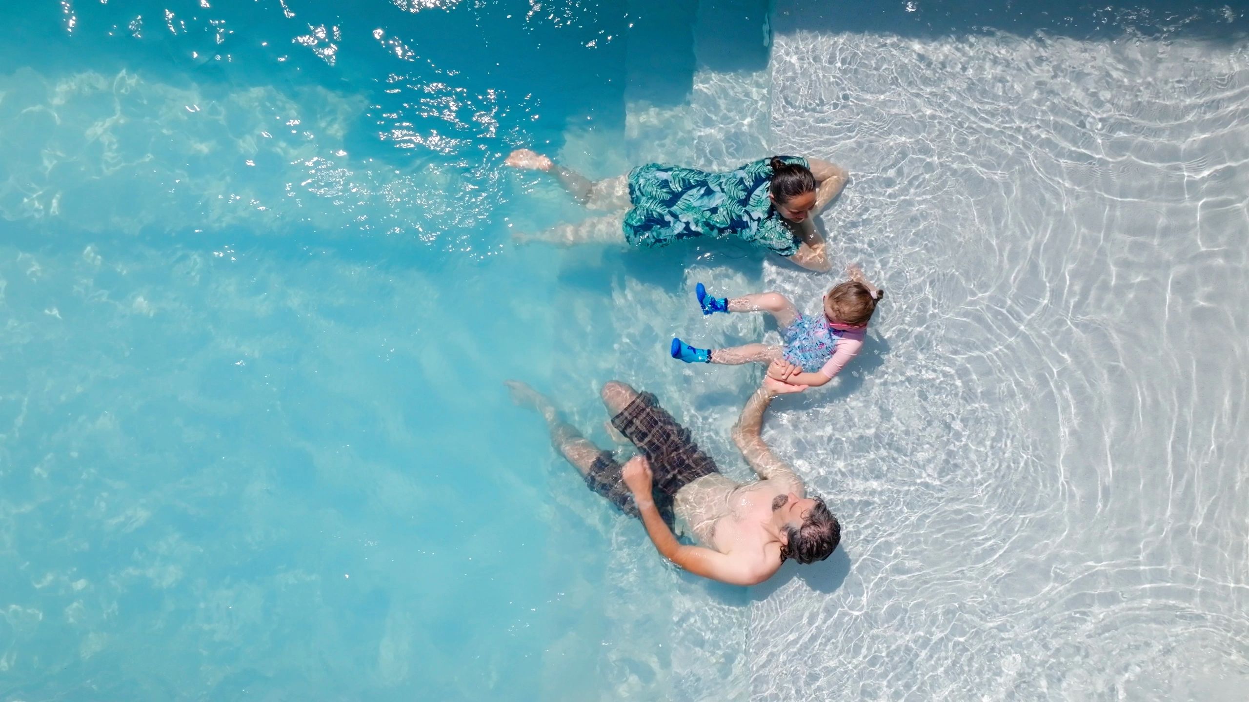 Family enjoying a tropical resort pool