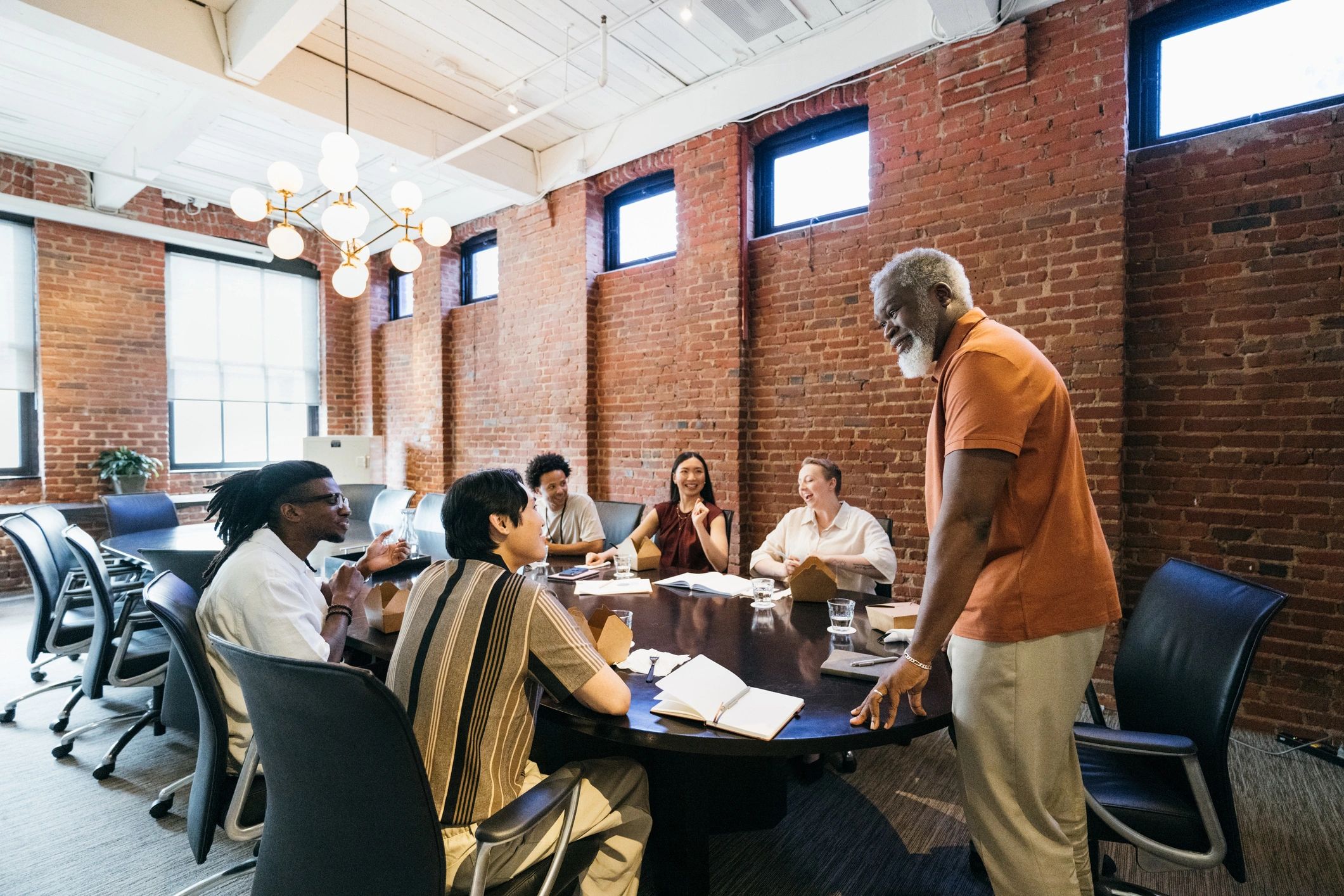 Business team sharing a boardroom lunch during an event break