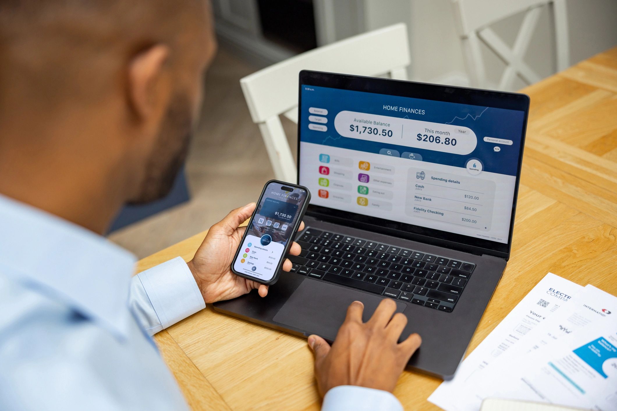 Customer reviewing account information on a laptop and phone